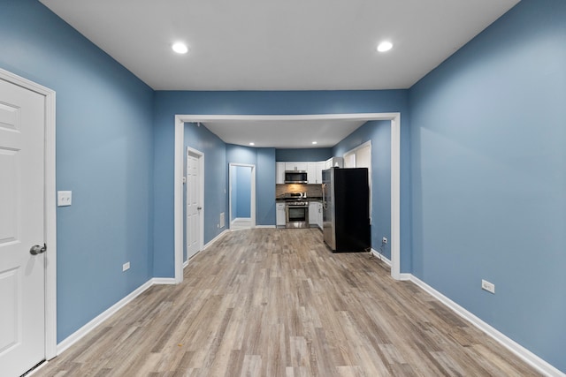 unfurnished living room with light hardwood / wood-style floors