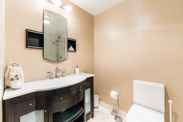 bathroom featuring vanity, tile patterned flooring, and toilet