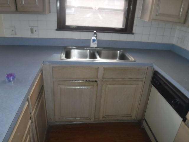 kitchen featuring dishwasher, light brown cabinets, backsplash, and sink