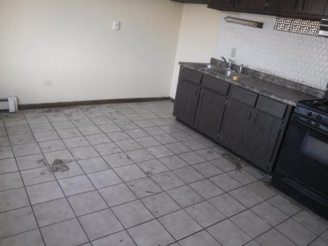 kitchen with black range with electric stovetop, sink, light tile patterned floors, and a baseboard heating unit