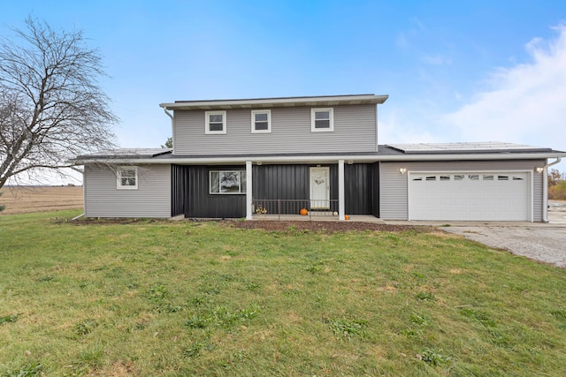 traditional home with a front yard, a garage, and driveway