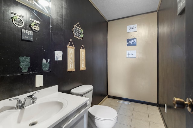 bathroom featuring tile patterned floors, vanity, a textured ceiling, and toilet