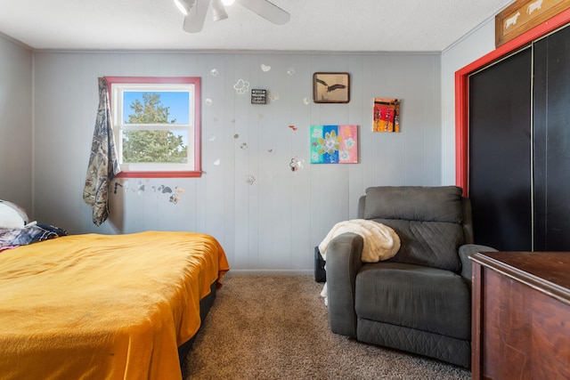 carpeted bedroom featuring a textured ceiling and ceiling fan