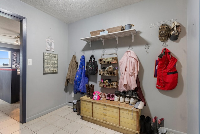 mudroom featuring tile patterned floors, ceiling fan, and a textured ceiling