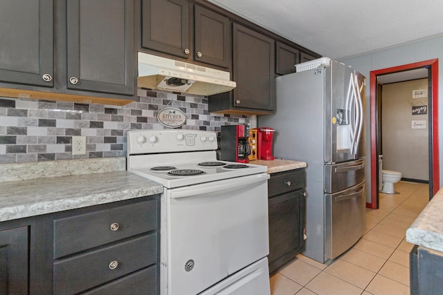 kitchen with tasteful backsplash, stainless steel refrigerator with ice dispenser, white electric stove, dark brown cabinets, and light tile patterned floors