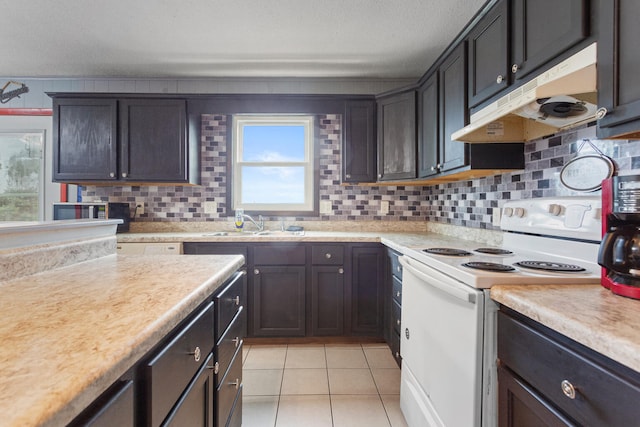 kitchen featuring tasteful backsplash, sink, light tile patterned flooring, and white electric stove