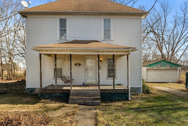 view of front of home with covered porch, a garage, an outdoor structure, and a front yard