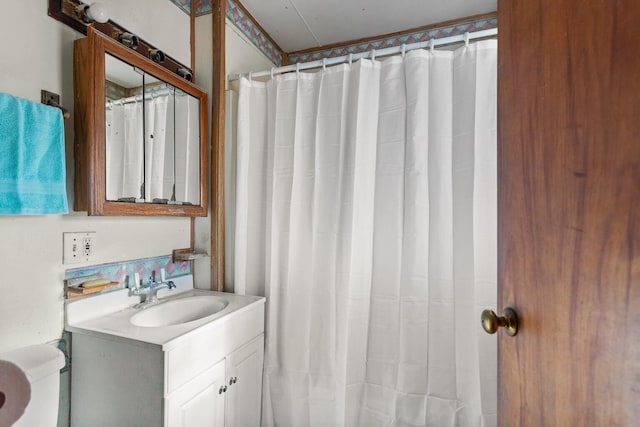 bathroom featuring vanity and curtained shower