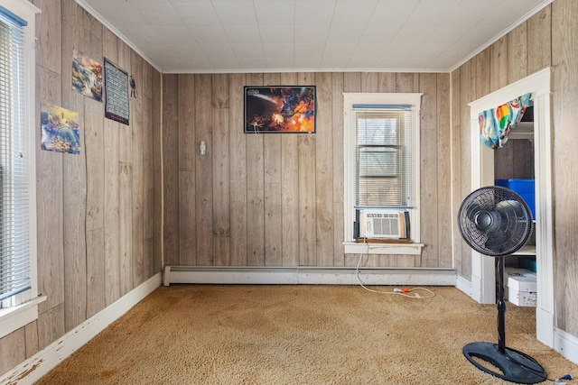 empty room featuring carpet flooring, wood walls, cooling unit, and a baseboard radiator