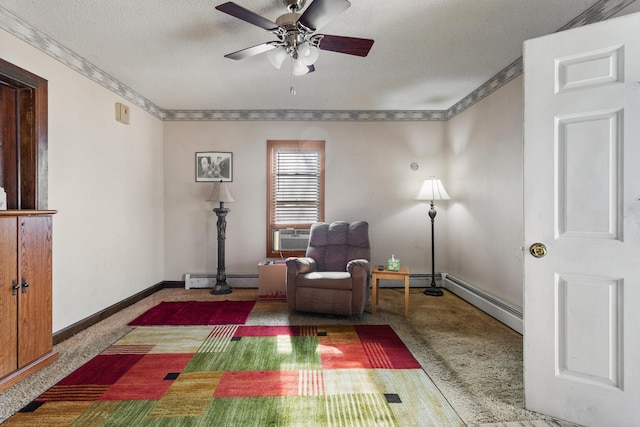 sitting room featuring carpet floors, a textured ceiling, baseboard heating, and ornamental molding