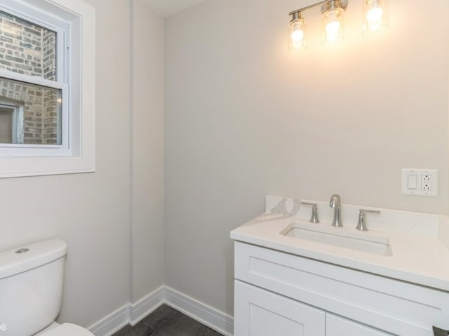 bathroom featuring vanity and toilet