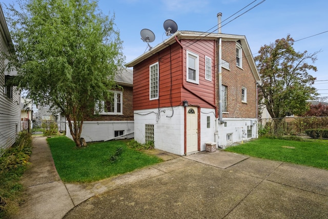 view of property exterior featuring a lawn