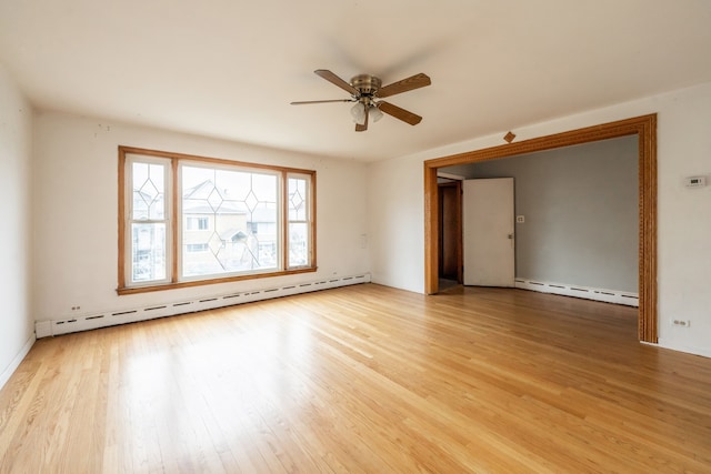 spare room with ceiling fan, light hardwood / wood-style flooring, and a baseboard heating unit