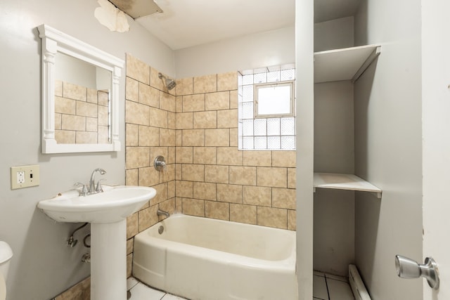 bathroom with tile patterned floors, toilet, and tiled shower / bath