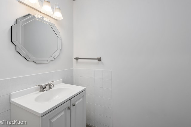 bathroom featuring vanity and tile walls