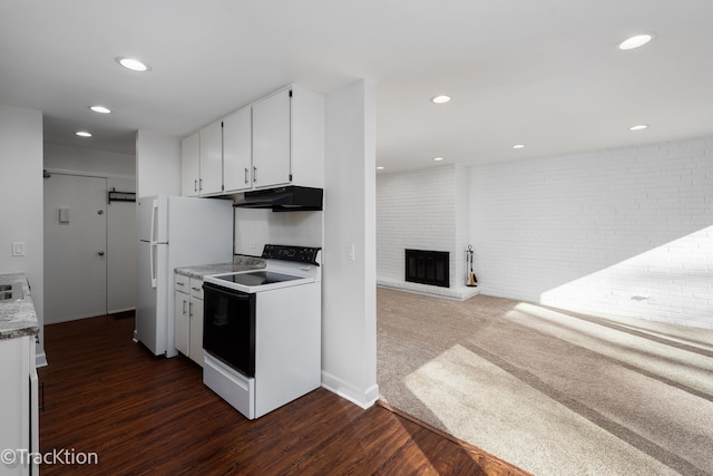 kitchen featuring white cabinetry, dark hardwood / wood-style flooring, a brick fireplace, white appliances, and brick wall