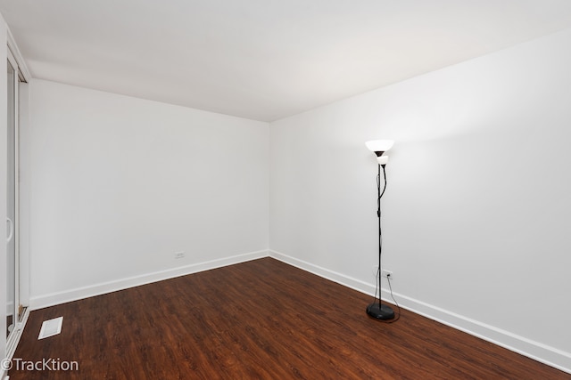 spare room with dark hardwood / wood-style floors