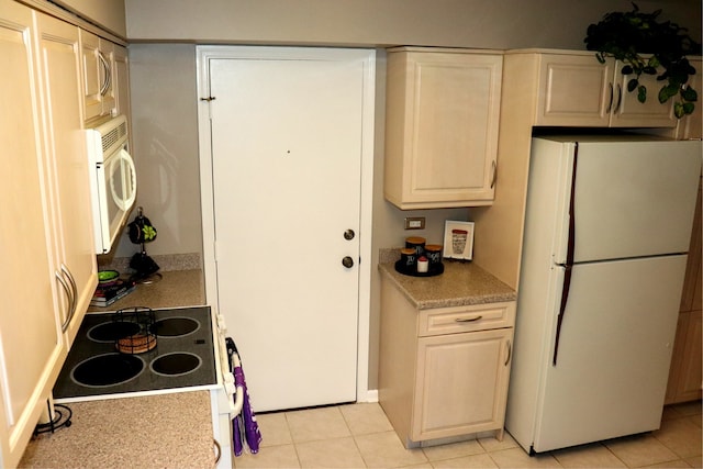 kitchen featuring white appliances and light tile patterned flooring