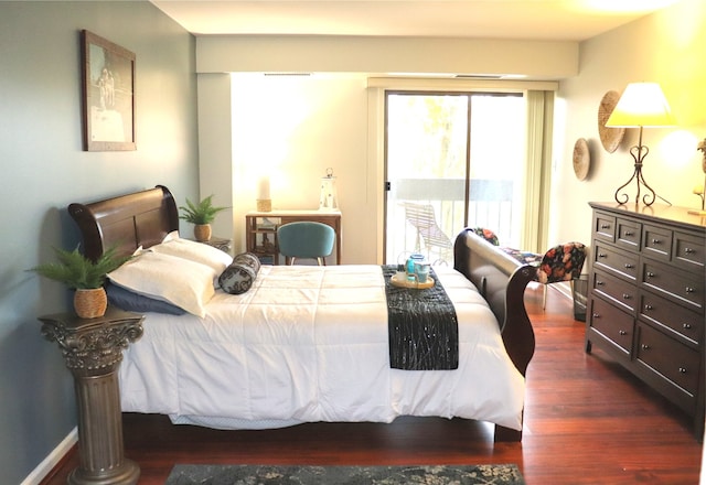 bedroom with dark hardwood / wood-style flooring and access to outside