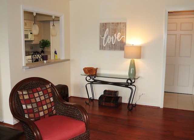 sitting room with wood-type flooring