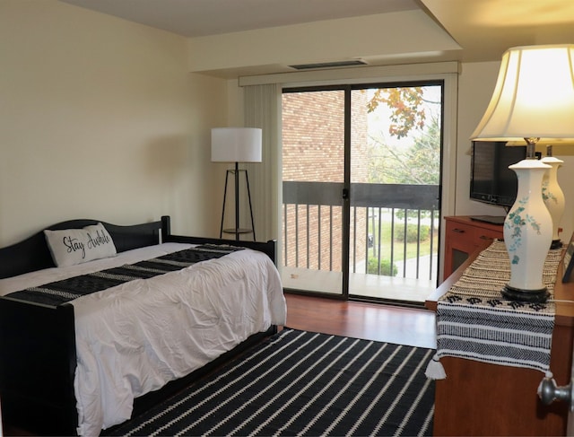 bedroom featuring access to outside and hardwood / wood-style flooring