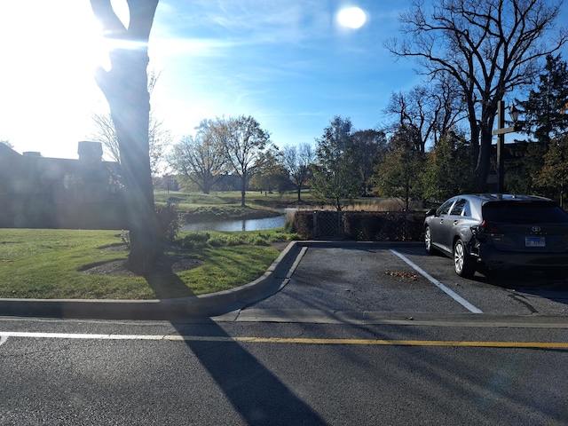 view of vehicle parking with a water view