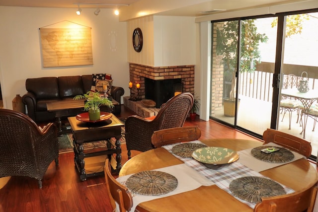 living room with wood-type flooring and a fireplace