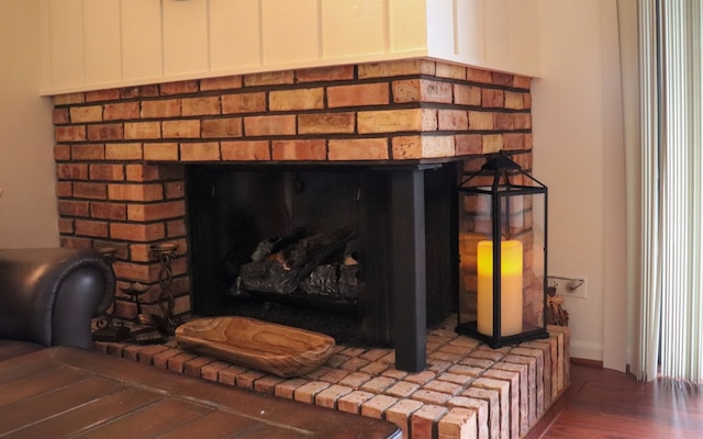 interior details featuring a fireplace and wood-type flooring