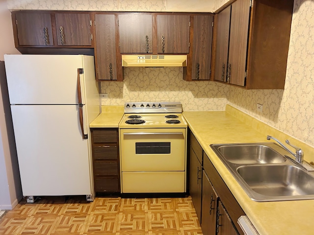 kitchen featuring light parquet flooring, electric range oven, sink, and white refrigerator