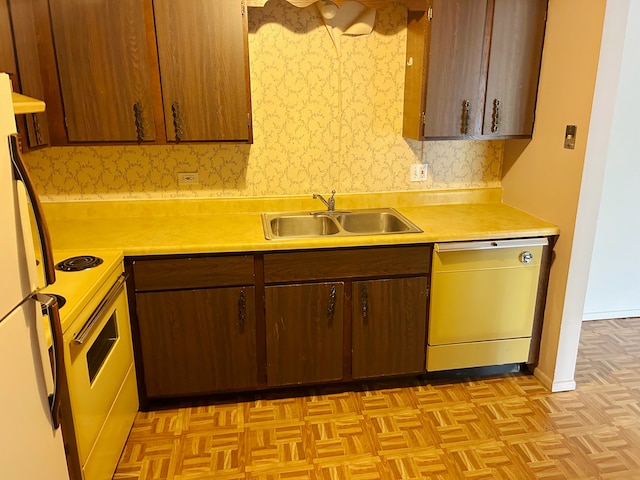 kitchen featuring light parquet flooring, dishwashing machine, sink, and white electric range oven