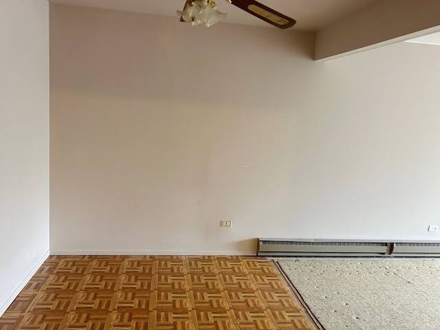 spare room featuring a baseboard radiator and light parquet floors