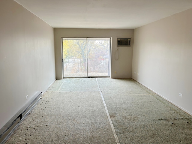 carpeted spare room with a wall unit AC and baseboard heating