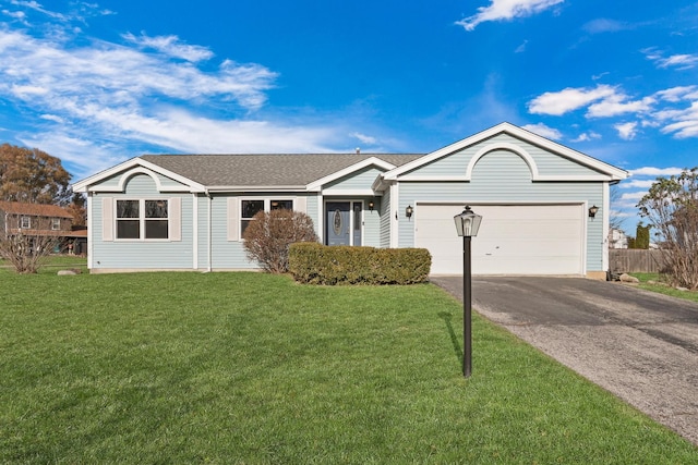 single story home with a garage and a front lawn