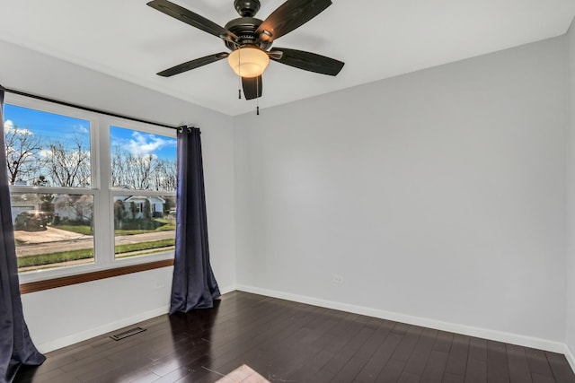 unfurnished room featuring ceiling fan and dark wood-type flooring