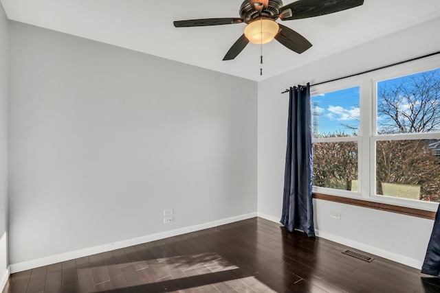 empty room featuring ceiling fan and dark wood-type flooring