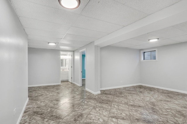 basement featuring a drop ceiling