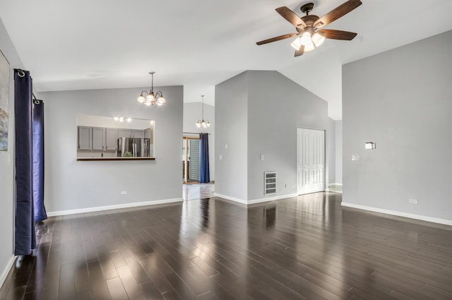 unfurnished living room with ceiling fan with notable chandelier, dark hardwood / wood-style flooring, and high vaulted ceiling