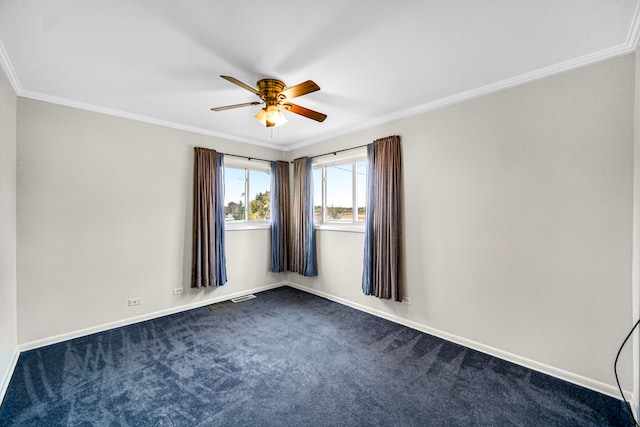 empty room with ceiling fan, crown molding, and dark carpet