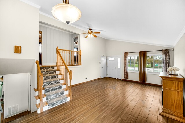 foyer entrance with crown molding, wood-type flooring, ceiling fan, and lofted ceiling