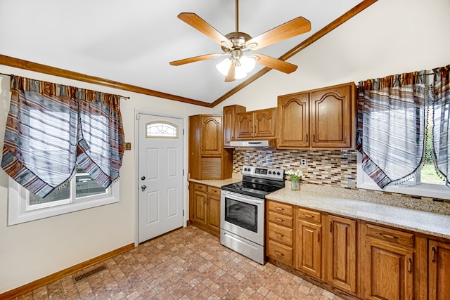 kitchen featuring ceiling fan, stainless steel range with electric stovetop, lofted ceiling, and tasteful backsplash