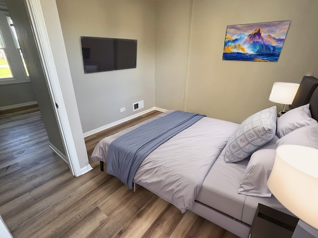 bedroom with wood-type flooring