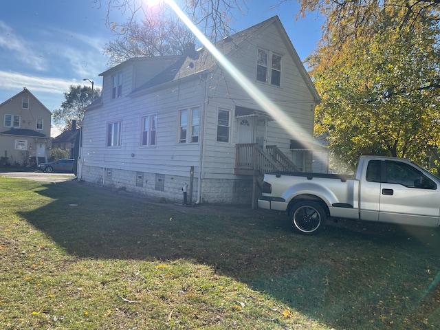 view of property exterior with a yard