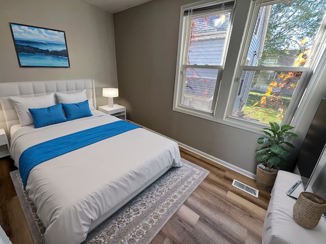 bedroom with hardwood / wood-style floors