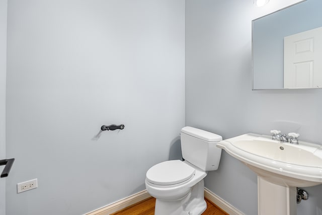 bathroom with wood-type flooring and toilet