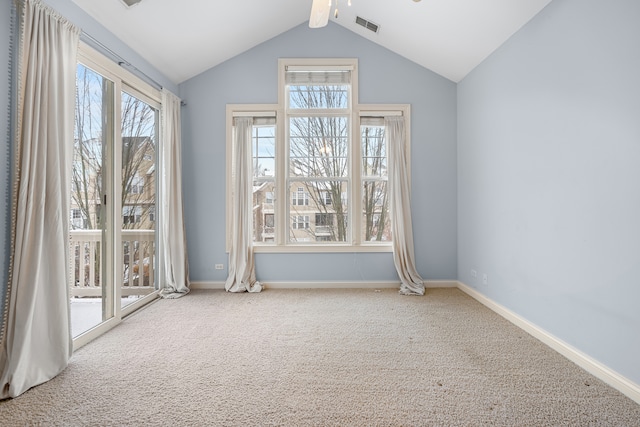 unfurnished room featuring vaulted ceiling with beams, ceiling fan, carpet flooring, and a wealth of natural light