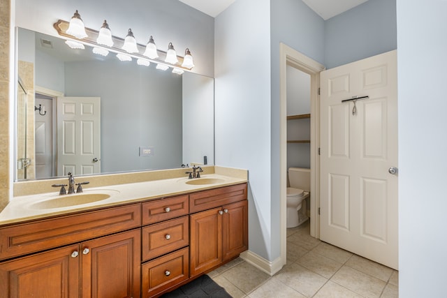 bathroom featuring tile patterned floors, vanity, and toilet