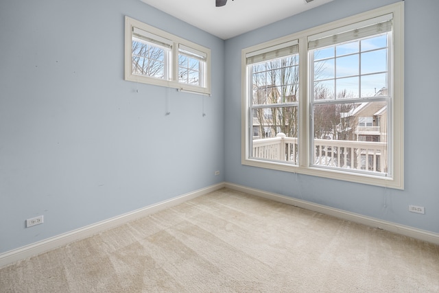 empty room with light carpet and ceiling fan