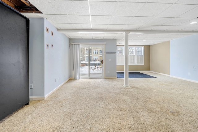 basement with carpet and a paneled ceiling