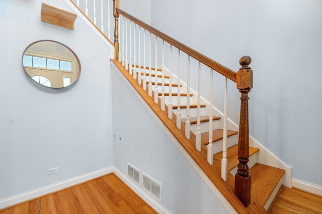 stairs with wood-type flooring