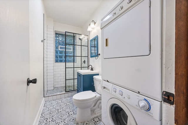 bathroom with vanity, tile patterned floors, toilet, and stacked washer / dryer